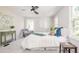 Bright bedroom featuring a ceiling fan, area rug, chair, and pillows with a cozy white bed at 2647 Wood Hollow Dr, Dunwoody, GA 30360