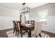 Cozy dining area with wainscoting, table, and windows for natural light at 2647 Wood Hollow Dr, Dunwoody, GA 30360