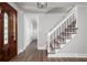 Inviting entryway with a decorative wood door, staircase, and wood-look flooring, providing a warm welcome at 2647 Wood Hollow Dr, Dunwoody, GA 30360