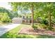 Charming two-story home with a landscaped front yard, two-car garage, and inviting front porch at 2647 Wood Hollow Dr, Dunwoody, GA 30360