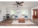 Bright living room with decorative seating, stylish furnishings, and natural light streaming through large windows at 2647 Wood Hollow Dr, Dunwoody, GA 30360