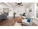 Open concept living room with built-in bookshelves, a fireplace, and large windows for natural light at 2647 Wood Hollow Dr, Dunwoody, GA 30360