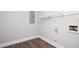 Functional utility room with wood-look flooring and basic electrical and plumbing hookups for appliances at 2647 Wood Hollow Dr, Dunwoody, GA 30360