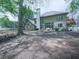 Extensive backyard with a fire pit, seating, wood pile and mature trees creating a serene outdoor space for relaxation and enjoyment at 3280 Peace Ln, Suwanee, GA 30024