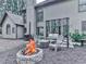 Backyard featuring a stone fire pit, comfortable seating, grill and large windows to view from the house at 3280 Peace Ln, Suwanee, GA 30024