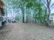 Picturesque backyard with mature trees, lush greenery, and a peaceful seating area, promising serene outdoor enjoyment at 3280 Peace Ln, Suwanee, GA 30024