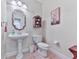 Charming powder room with a pedestal sink, decorative mirror, and stylish decor at 3280 Peace Ln, Suwanee, GA 30024