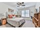 Comfortable bedroom with a decorative bed, ceiling fan, and natural light from a window at 3280 Peace Ln, Suwanee, GA 30024