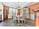 Elegant dining room with classic furniture, decorative accents, and ample natural light from the windows at 3280 Peace Ln, Suwanee, GA 30024