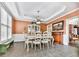 Bright dining room with traditional furnishings, crown molding, and ample natural light from the windows at 3280 Peace Ln, Suwanee, GA 30024