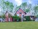 Beautiful brick home with mature landscaping, a well manicured lawn, and a circular driveway at 3280 Peace Ln, Suwanee, GA 30024