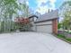 Charming home featuring an attached garage, a welcoming driveway, and beautiful landscaping, enhanced by a mature Japanese maple at 3280 Peace Ln, Suwanee, GA 30024