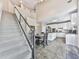 Open-concept kitchen with stairs, island seating, stainless steel appliances, and ample natural light at 3280 Peace Ln, Suwanee, GA 30024