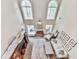 Spacious living room with tall windows, fireplace, ceiling fan, and plush seating, perfect for relaxation at 3280 Peace Ln, Suwanee, GA 30024