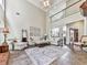 Bright living room with high ceilings, a fireplace, and ample seating for entertaining guests at 3280 Peace Ln, Suwanee, GA 30024