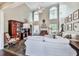 The spacious living room features a fireplace, multiple windows, and a high ceiling at 3280 Peace Ln, Suwanee, GA 30024