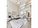 Bright, open living room with high ceilings, plush seating, and a decorative area rug at 3280 Peace Ln, Suwanee, GA 30024