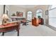 Cozy living room/office with comfortable seating, a desk, and ample natural light from arched windows at 3280 Peace Ln, Suwanee, GA 30024
