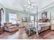 Serene bedroom with a four-poster bed, comfortable seating, and hardwood floors at 3280 Peace Ln, Suwanee, GA 30024
