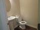 Cozy powder room featuring a pedestal sink and modern toilet at 3352 Brockenhurst Dr, Buford, GA 30519