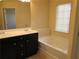 Bright bathroom features a double vanity and a separate soaking tub at 3352 Brockenhurst Dr, Buford, GA 30519