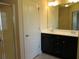 Bathroom featuring dual sinks, dark cabinets, and a glass-enclosed shower at 3352 Brockenhurst Dr, Buford, GA 30519