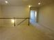 This bonus room has neutral carpeting with a staircase and open doorway at 3352 Brockenhurst Dr, Buford, GA 30519