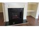 Elegant fireplace featuring a white mantel, black hearth, and built-in shelving at 3352 Brockenhurst Dr, Buford, GA 30519