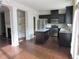 Bright, open kitchen with dark cabinets, stainless appliances, and a center island, adjoining living space at 3352 Brockenhurst Dr, Buford, GA 30519