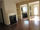 Cozy living room with a fireplace and easy access to the kitchen, creating an ideal space for entertaining at 3352 Brockenhurst Dr, Buford, GA 30519