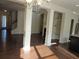 Spacious living area showcases decorative columns, and hardwood floors; a versatile space for gathering at 3352 Brockenhurst Dr, Buford, GA 30519