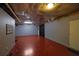 Unfinished basement space with painted walls, drop ceiling, and doorway to possible storage at 1514 Log Cabin Ln, Lawrenceville, GA 30045