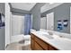 Bathroom featuring a vanity with sink, toilet, and a shower/tub combo with blue shower curtain at 1514 Log Cabin Ln, Lawrenceville, GA 30045