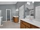 Bathroom featuring double sink vanity, neutral tile flooring, a walk-in closet, and grey walls at 1514 Log Cabin Ln, Lawrenceville, GA 30045
