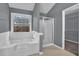 Primary bathroom with a large tub, shower, and gray walls at 1514 Log Cabin Ln, Lawrenceville, GA 30045