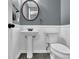 Cozy half bathroom with a pedestal sink and a toilet at 1514 Log Cabin Ln, Lawrenceville, GA 30045