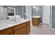 Bathroom featuring a double sink vanity, neutral tile flooring, and a walk-in shower at 1514 Log Cabin Ln, Lawrenceville, GA 30045