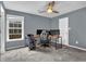 Bedroom with plush carpet, a ceiling fan, and natural light from the windows at 1514 Log Cabin Ln, Lawrenceville, GA 30045