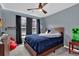 Bedroom with plush carpet, a ceiling fan, and natural light from the windows at 1514 Log Cabin Ln, Lawrenceville, GA 30045