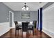 Elegant dining room featuring hardwood floors, wainscoting, a chandelier, and ample natural light at 1514 Log Cabin Ln, Lawrenceville, GA 30045