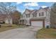 Charming two-story home with a two-car garage and manicured front lawn at 1514 Log Cabin Ln, Lawrenceville, GA 30045