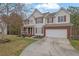 Charming two-story home featuring a brick-accented garage, front porch, and well-maintained landscaping at 1514 Log Cabin Ln, Lawrenceville, GA 30045