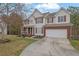 Charming two-story home with a two-car garage and well-manicured front lawn at 1514 Log Cabin Ln, Lawrenceville, GA 30045