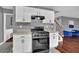 Well-lit kitchen featuring white cabinets, gray walls, and modern appliances at 1514 Log Cabin Ln, Lawrenceville, GA 30045