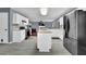 Open concept kitchen with an island, stainless steel refrigerator, and gray flooring at 1514 Log Cabin Ln, Lawrenceville, GA 30045