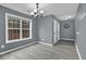 Living room features a large window, gray walls, and gray floors at 1514 Log Cabin Ln, Lawrenceville, GA 30045