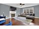 Spacious living room featuring hardwood floors, a fireplace, large windows, and comfortable seating at 1514 Log Cabin Ln, Lawrenceville, GA 30045
