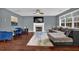 Spacious living room featuring hardwood floors, a fireplace, large windows, and comfortable seating at 1514 Log Cabin Ln, Lawrenceville, GA 30045