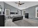 Bright main bedroom with a ceiling fan, gray walls, and windows at 1514 Log Cabin Ln, Lawrenceville, GA 30045