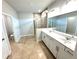 This bathroom boasts double sinks with modern fixtures and lighting, plus walk-in shower and separate toilet room at 1769 Rowland Pass, Buford, GA 30518